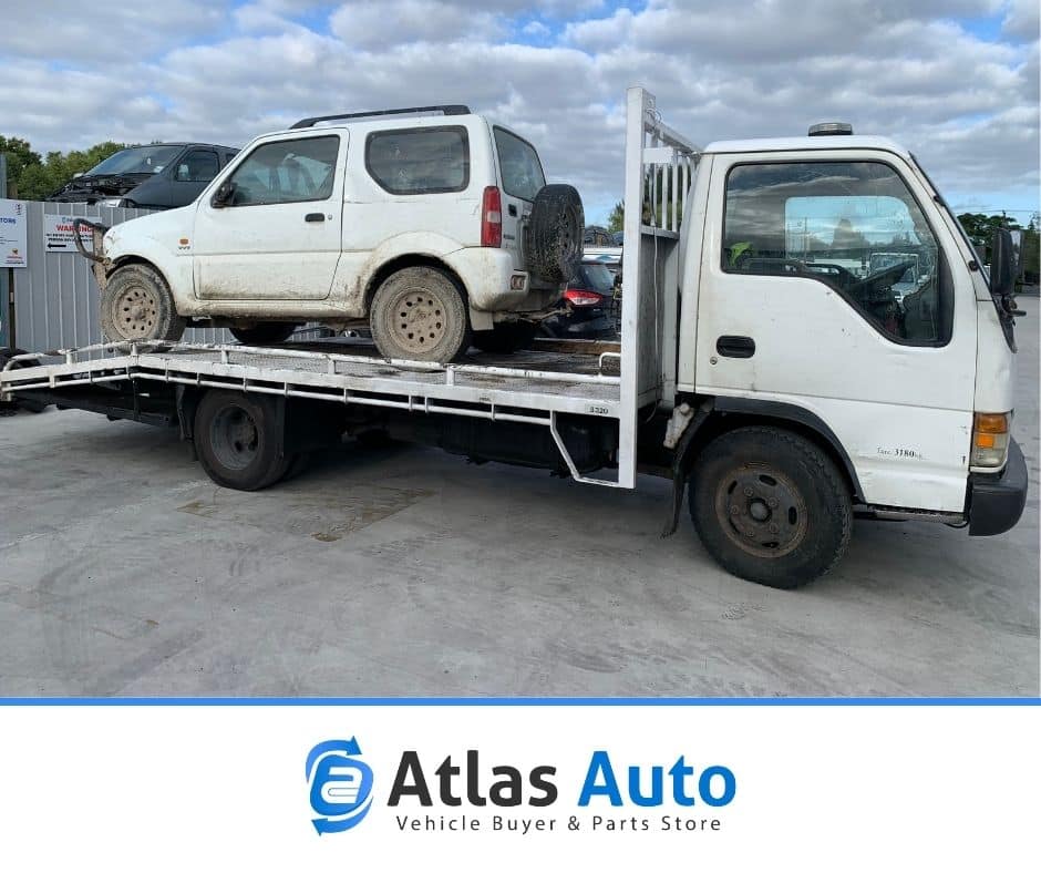 A car being towed away by Atlas Auto's car removal service in Thames.